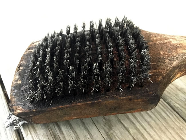 Close up photo of wire brush grill cleaner.